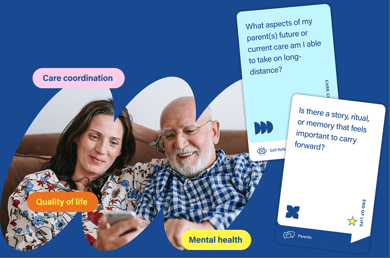 Caregiver and elderly person looking at conversation cards